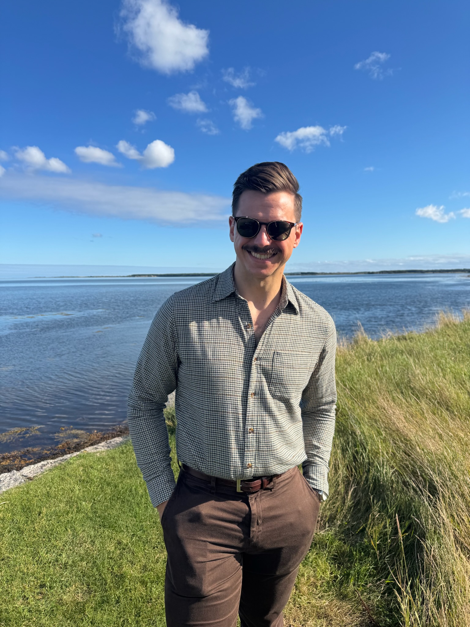 John in front of a coastline