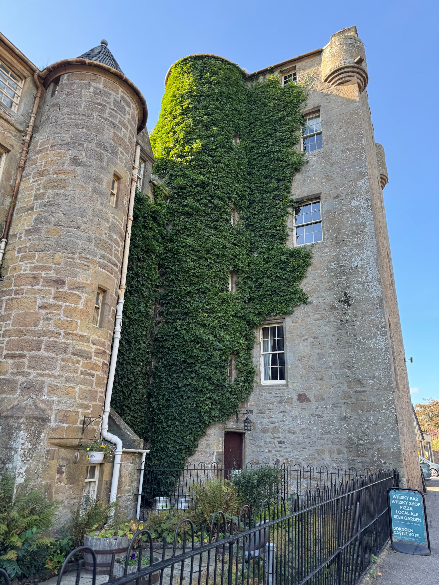 An old stone tower with ivy climbing up the side of it.